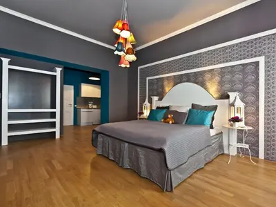 a bedroom with a large bed and blue walls at Royal Prague City Apartments in Prague