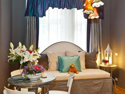 a couch with a teddy bear on it in a room at Royal Prague City Apartments in Prague
