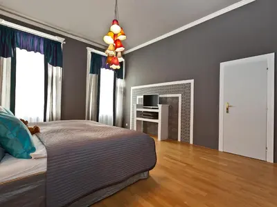a bedroom with a bed and a fireplace and a television at Royal Prague City Apartments in Prague