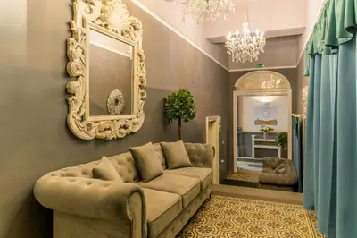 a living room with a couch and a mirror at Royal Prague City Apartments in Prague