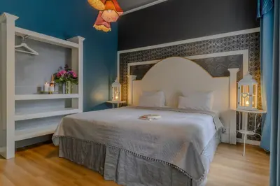 a bedroom with a white bed and blue walls at Royal Prague City Apartments in Prague