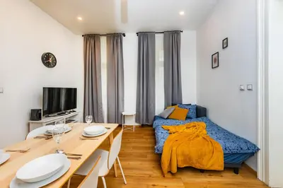 a small apartment with a dining table and a bed at Pat & Mat Apartment in Prague