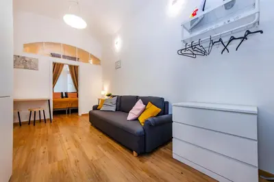 a living room with a couch and a dresser at Pat & Mat Apartment in Prague