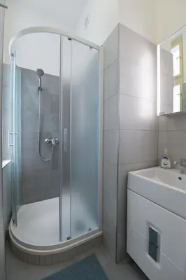 a bathroom with a shower and a sink at Pat & Mat Apartment in Prague