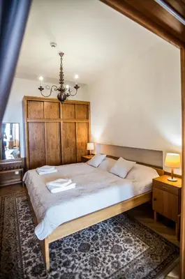 a bedroom with a large bed and a chandelier at Opitzův dům in Prague