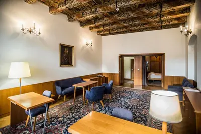 a waiting room with blue chairs and tables at Opitzův dům in Prague
