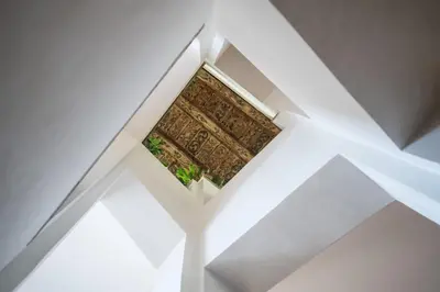 an opening in the ceiling of a room with a window at Opitzův dům in Prague