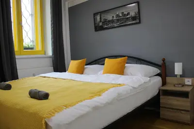 a bedroom with a bed with a yellow blanket at LYLY APARTMENT - Modern apartment with free parking in Prague