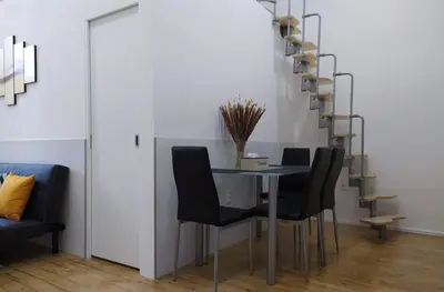 a dining room with a glass table and black chairs at LYLY APARTMENT - Modern apartment with free parking in Prague