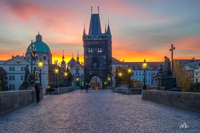 a large building with a clock tower at sunset at LYLY APARTMENT - Modern apartment with free parking in Prague