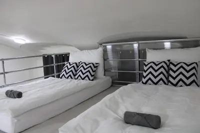 a bedroom with two beds and pillows on a boat at LYLY APARTMENT - Modern apartment with free parking in Prague