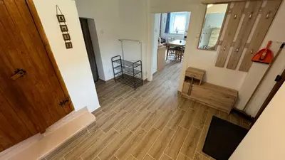 an empty hallway with a wooden floor and a room at Ubytování Bauštel in Kochovice