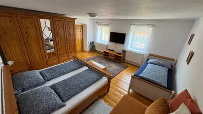 a room with two beds and a flat screen tv at Ubytování Bauštel in Kochovice