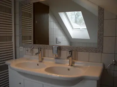 a bathroom with a sink with a window and a mirror at Penzion Rozkoš in Pruhonice