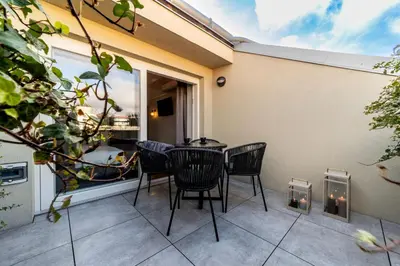 a patio with chairs and a table and a window at The Viaduct - Suites & More in Prague