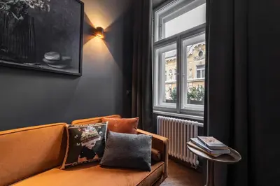 a living room with a couch and a window at The Viaduct - Suites & More in Prague