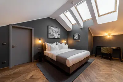 a bedroom with a large bed and a skylight at The Viaduct - Suites & More in Prague