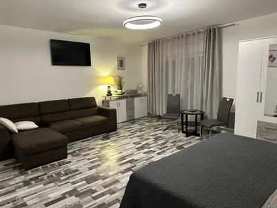 a bedroom with a couch and a living room at Apartmány Piller in Roudnice nad Labem