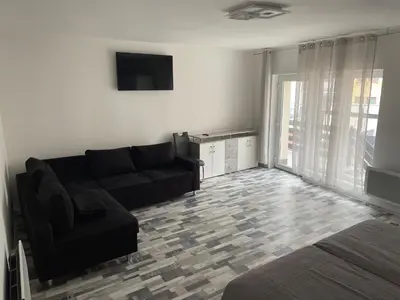 a living room with a couch and a tv at Apartmány Piller in Roudnice nad Labem
