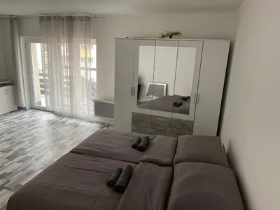 a bedroom with a bed and a large mirror at Apartmány Piller in Roudnice nad Labem