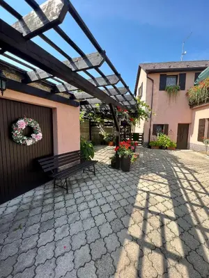 a bench sitting under a pergola next to a building at Restaurace a penzion Na Růžku in Mořina