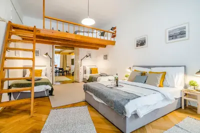 a bedroom with a loft bed and a ladder at Florenc Apartments Prague 1 by Michal&Friends in Prague