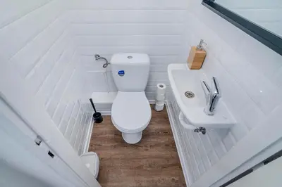 a white bathroom with a toilet and a sink at Florenc Apartments Prague 1 by Michal&Friends in Prague