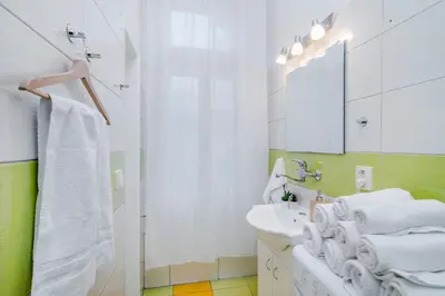 a white bathroom with a sink and a mirror at Florenc Apartments Prague 1 by Michal&Friends in Prague
