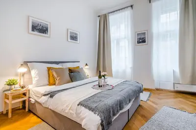 a bedroom with a large bed with a table on it at Florenc Apartments Prague 1 by Michal&Friends in Prague