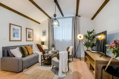 a living room with a couch and a tv at Florenc Apartments Prague 1 by Michal&Friends in Prague