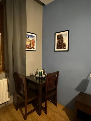 a dining room with a table with bottles and chairs at Central Studios in Prague