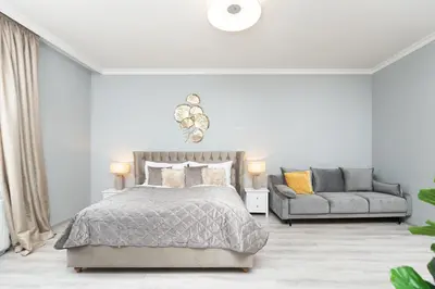 a white bedroom with a bed and a couch at Luxury Central 150m2 Apartment on Wencelas Square with Private Garage in Prague