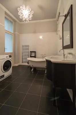 a bathroom with a tub and a sink and a washing machine at Luxury Central 150m2 Apartment on Wencelas Square with Private Garage in Prague