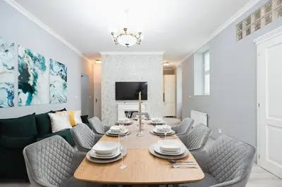 a dining room with a wooden table and chairs at Luxury Central 150m2 Apartment on Wencelas Square with Private Garage in Prague