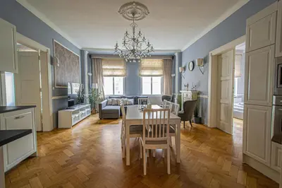 a kitchen and living room with a table and chairs at Luxury Central 150m2 Apartment on Wencelas Square with Private Garage in Prague