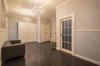 a living room with a couch and a chandelier at Luxury Central 150m2 Apartment on Wencelas Square with Private Garage in Prague