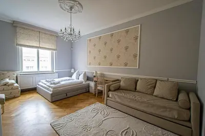 a living room with a couch and a table at Luxury Central 150m2 Apartment on Wencelas Square with Private Garage in Prague