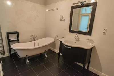 a bathroom with a tub and a sink at Luxury Central 150m2 Apartment on Wencelas Square with Private Garage in Prague