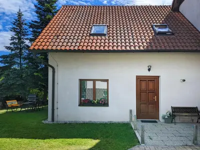 a white house with a door and a window at Guest House KRISTI in Tuchoměřice