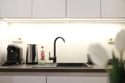 a kitchen counter with a sink and a coffee maker at Heart of Old Town Apartment by National Theater in Prague