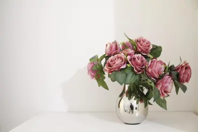 a vase filled with pink flowers on a table at Heart of Old Town Apartment by National Theater in Prague