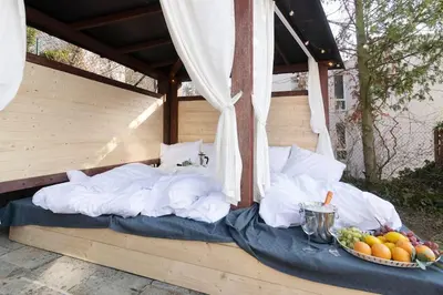 a bed sitting under a canopy with a bowl of fruit at Miami Lovely romantic Garden apartment with whirlpool in Prague