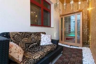 a living room with a couch and a window at Miami Lovely romantic Garden apartment with whirlpool in Prague