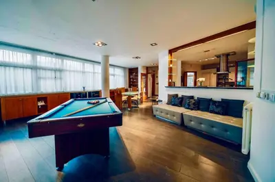a living room with a pool table and a couch at Miami Lovely romantic Garden apartment with whirlpool in Prague