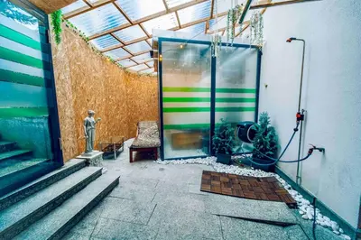 a room with a glass door in a building at Miami Lovely romantic Garden apartment with whirlpool in Prague