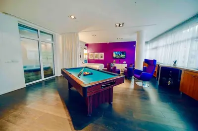 a living room with a pool table in it at Miami Lovely romantic Garden apartment with whirlpool in Prague