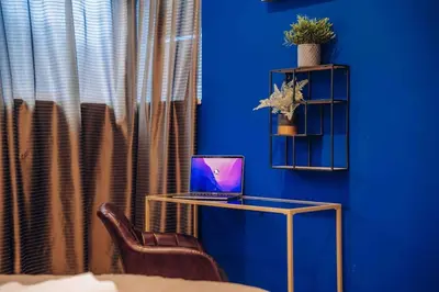 a blue room with a desk with a laptop on it at Unique apartment with private pool, cinema, SPA in Prague