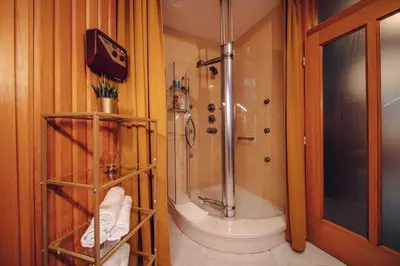 a bathroom with a shower and a toilet and a sink at Unique apartment with private pool, cinema, SPA in Prague