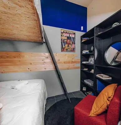 a bedroom with a bed and a red chair at Unique apartment with private pool, cinema, SPA in Prague