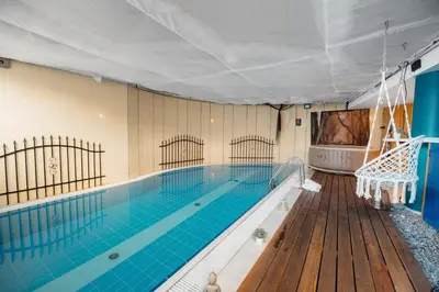 a large swimming pool with a large swimming pool at Unique apartment with private pool, cinema, SPA in Prague